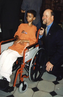 Michael F. Guilford and wheelchair-bound person.